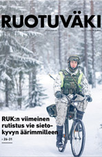 RUK:n upseerioppilas pyöräilee taisteluvarustuksessa talvella.