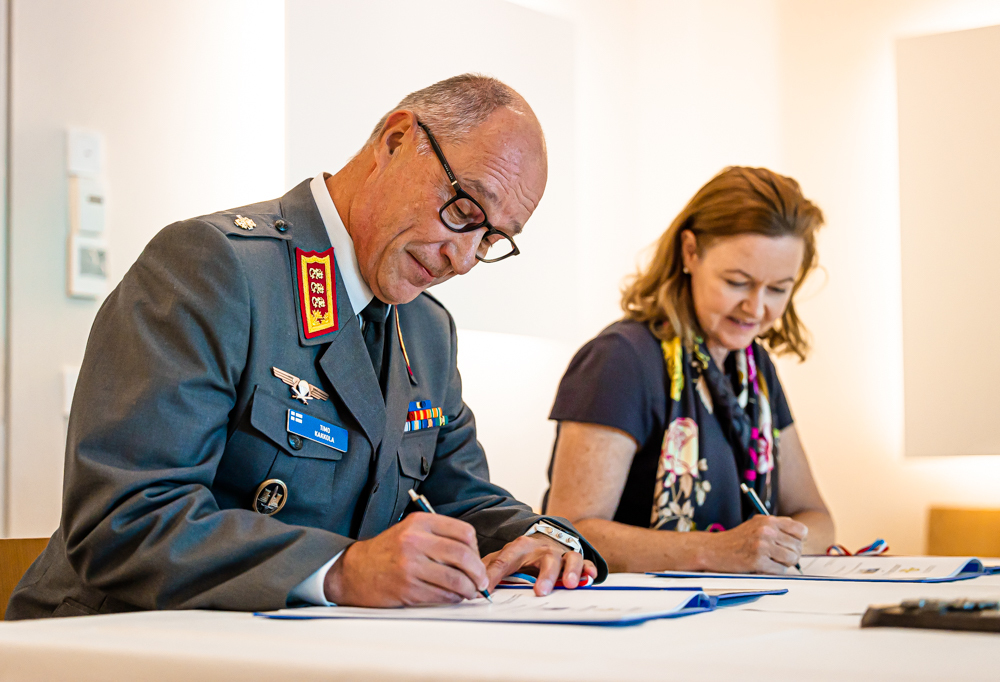Kuvassa kenraaliluutnantti Timo Kakkola ja Stacy Cummings allekirjoittavat asiakirjan