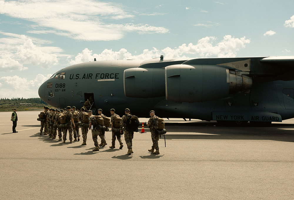 Reserviläiset siirtyvät Yhdysvaltojen asevoimien sotilaslentokoneen kyytiin.