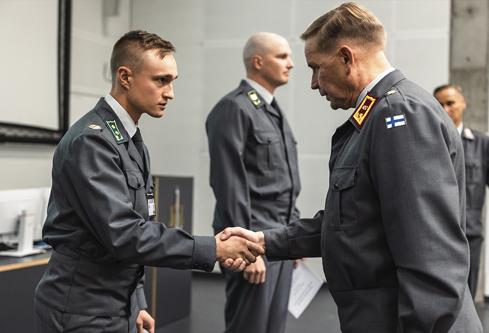 Palkintoviireillä palkitut kouluttajat seisovat rivissä.