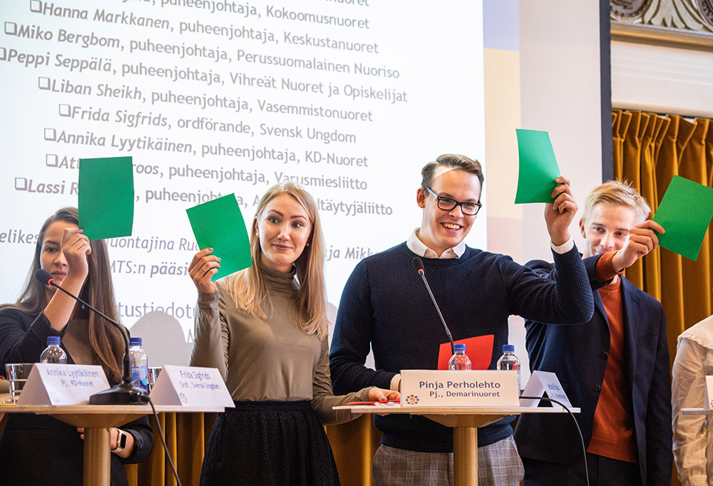 Kuvassa RKP-nuorten, Sosialidemokraattisten Nuorten, Kokoomusnuorten ja Perussuomalaissen Nuorison puheenjohtajat pitävät esillä vihreitä äänestyslappuja.