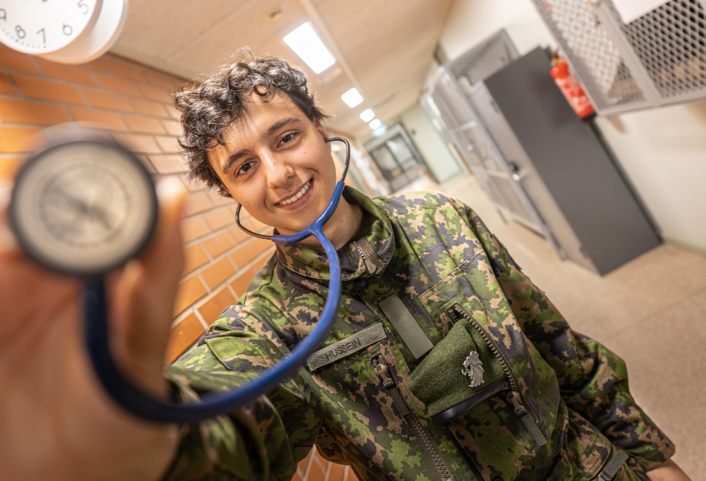 Omar Hussein hymyilee stetoskooppi kädessään.