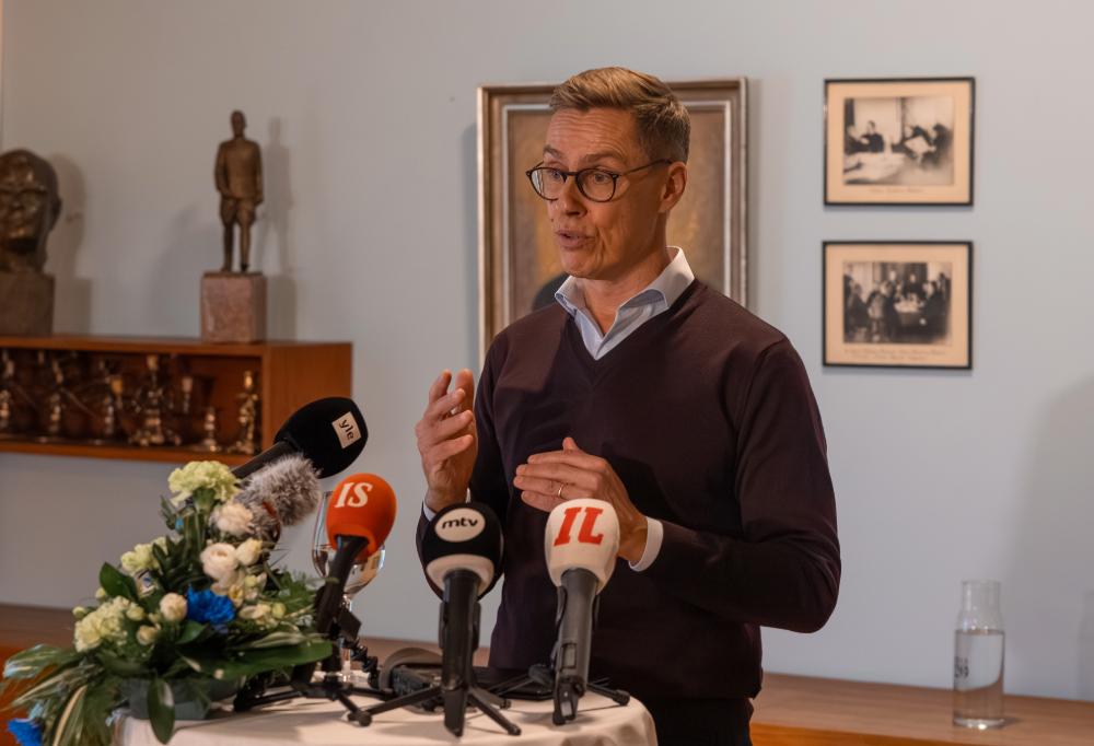 Stubb puhumassa lehdistölle historiallisessa huoneessa.