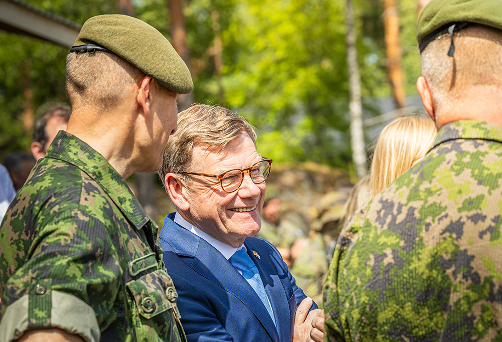 Johann Wadephul nauraa ja keskustelee sotilaiden kanssa.